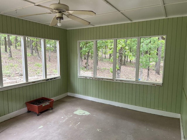 unfurnished sunroom with a ceiling fan