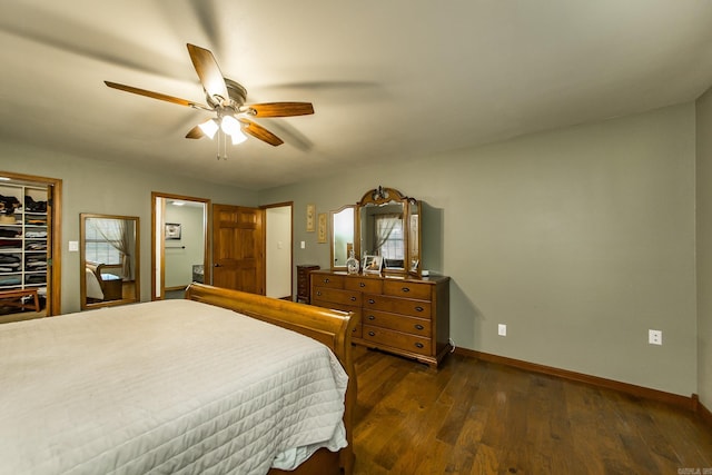 bedroom featuring baseboards, a ceiling fan, and dark wood-style flooring