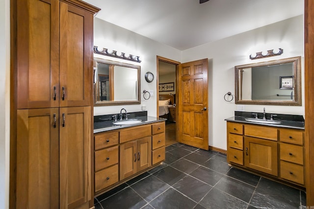 ensuite bathroom with a sink, ensuite bath, and two vanities