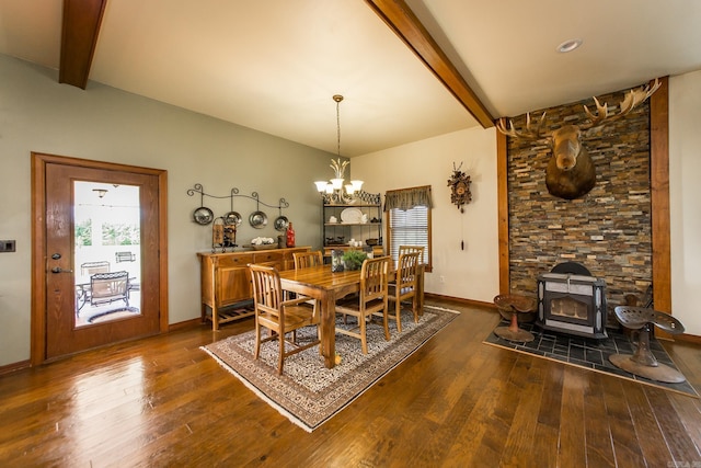dining room with a wood stove, dark wood-style flooring, beam ceiling, baseboards, and a chandelier