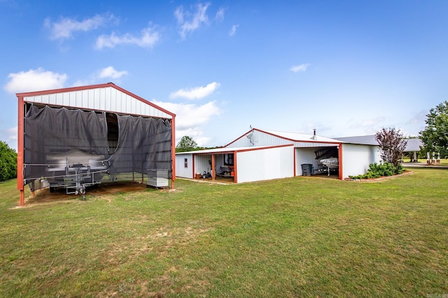 exterior space featuring a garage, an outbuilding, and an outdoor structure