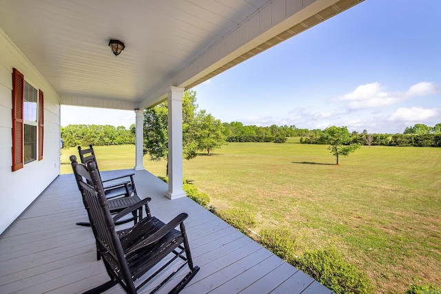 wooden deck featuring a yard and covered porch
