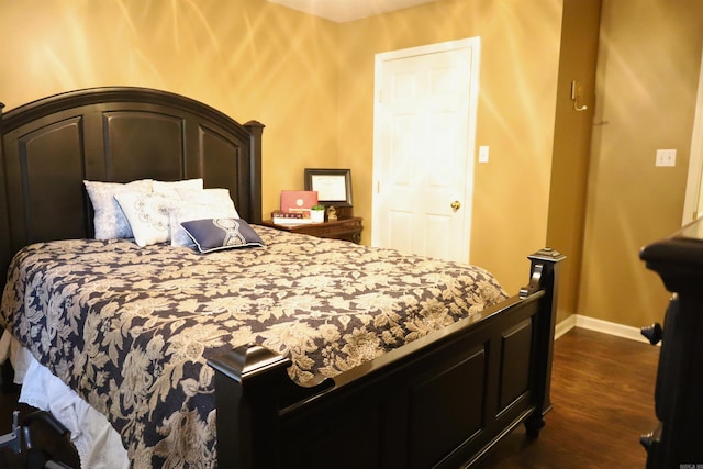 3302 Willow Ln, Paragould, AR 72450 - bedroom featuring dark wood-style flooring and baseboards