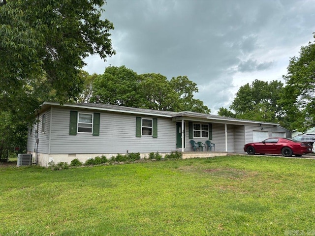 view of front of home featuring a porch, central AC, a front yard, and a garage