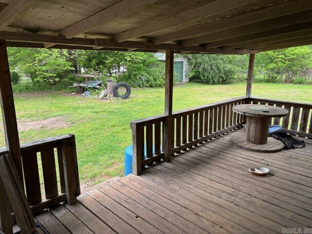 wooden deck with a lawn