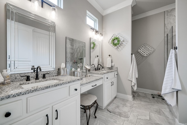 full bath with a sink, two vanities, a tile shower, and marble finish floor