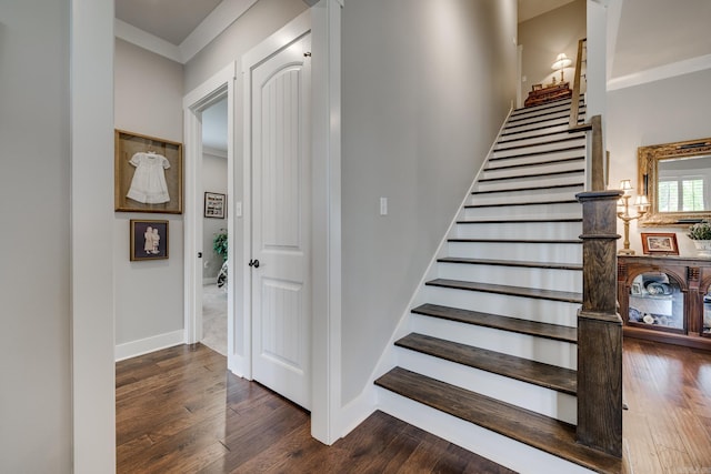 stairs featuring baseboards and wood finished floors