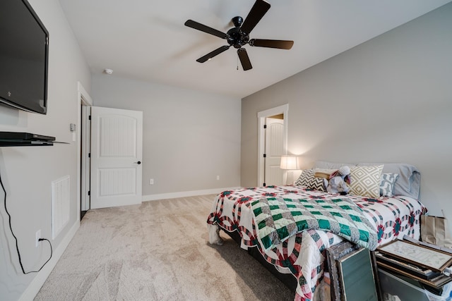 carpeted bedroom with baseboards, ceiling fan, and visible vents