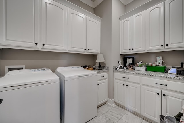 laundry area with cabinet space, marble finish floor, and washer and dryer