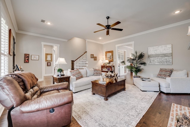 living room featuring stairway, a ceiling fan, dark wood-style floors, and visible vents