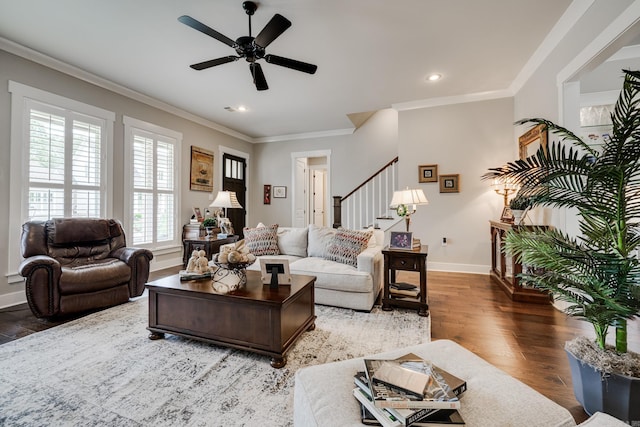 living area featuring baseboards, stairs, ceiling fan, and wood finished floors