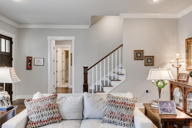 living area with baseboards, wood finished floors, and stairway