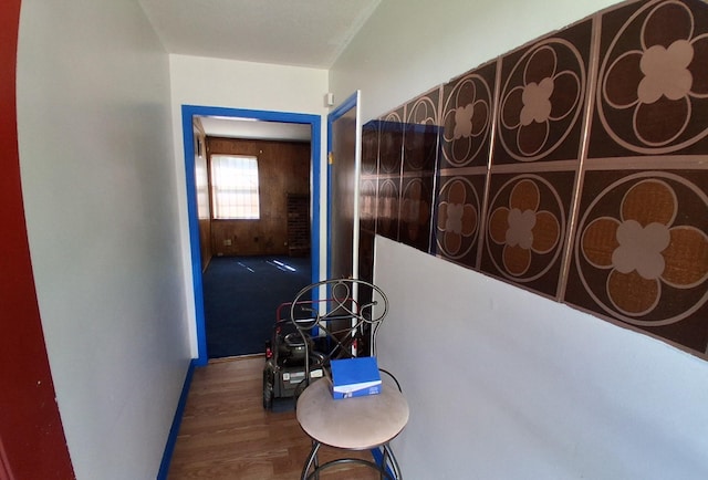 hall featuring baseboards and wood finished floors