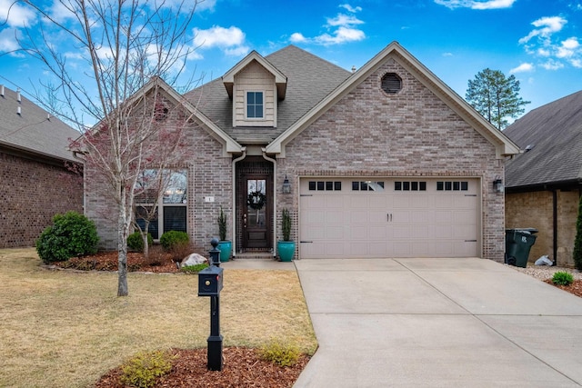 view of front of property with a shingled roof, an attached garage, a front lawn, brick siding, and concrete driveway