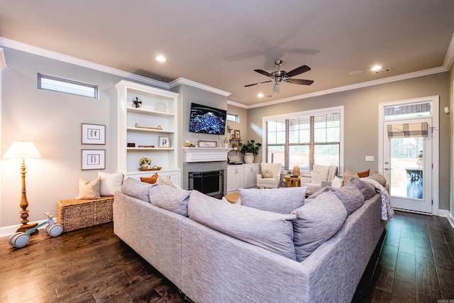 living room featuring crown molding, a fireplace, and dark wood-style floors