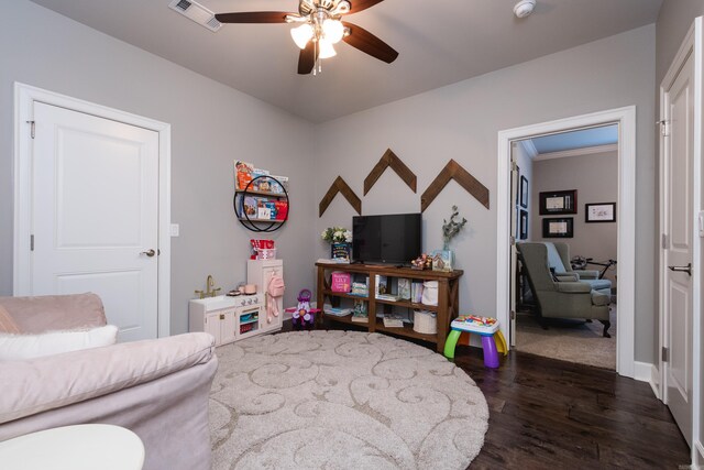 rec room with baseboards, ceiling fan, dark wood-type flooring, and visible vents