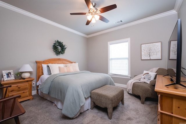 carpeted bedroom featuring a ceiling fan, baseboards, visible vents, and ornamental molding