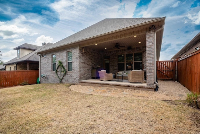 rear view of house featuring an outdoor living space, a ceiling fan, a fenced backyard, and a patio