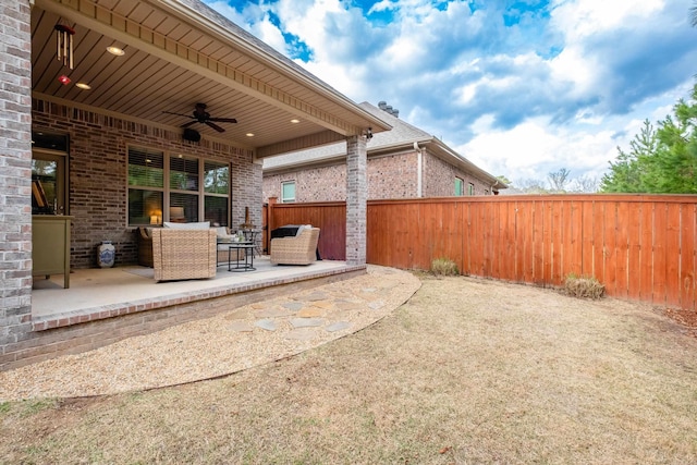 view of patio / terrace featuring a fenced backyard, ceiling fan, and outdoor lounge area