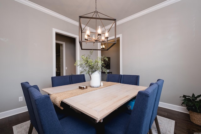 dining space with baseboards, dark wood-style flooring, crown molding, and a notable chandelier