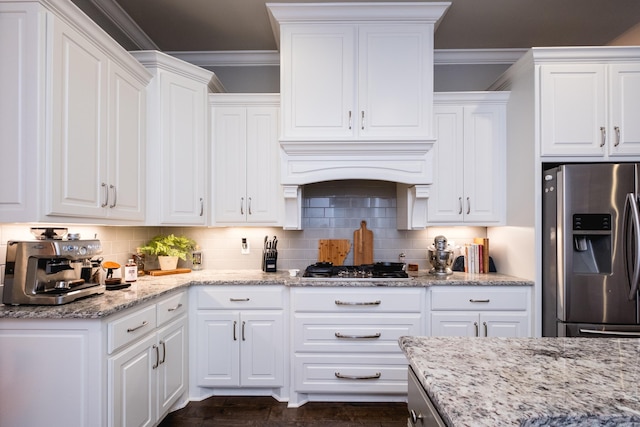 kitchen featuring crown molding, stainless steel appliances, and white cabinets