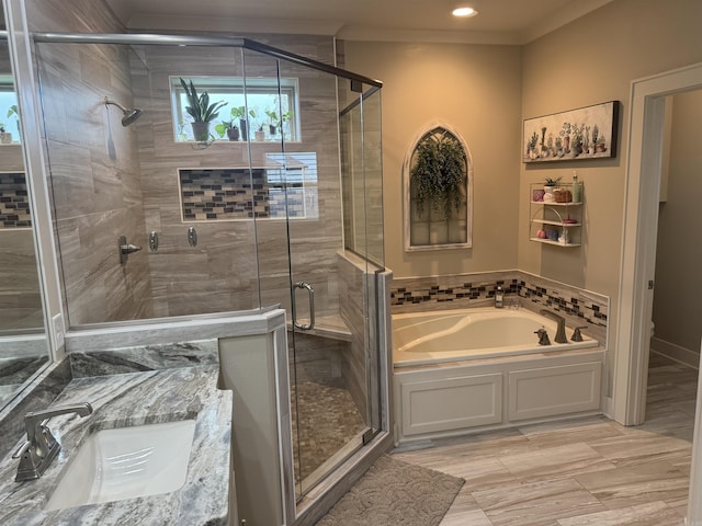 2560 Lilac Dr, Conway, AR 72034 - bathroom featuring a sink, a garden tub, a stall shower, ornamental molding, and toilet