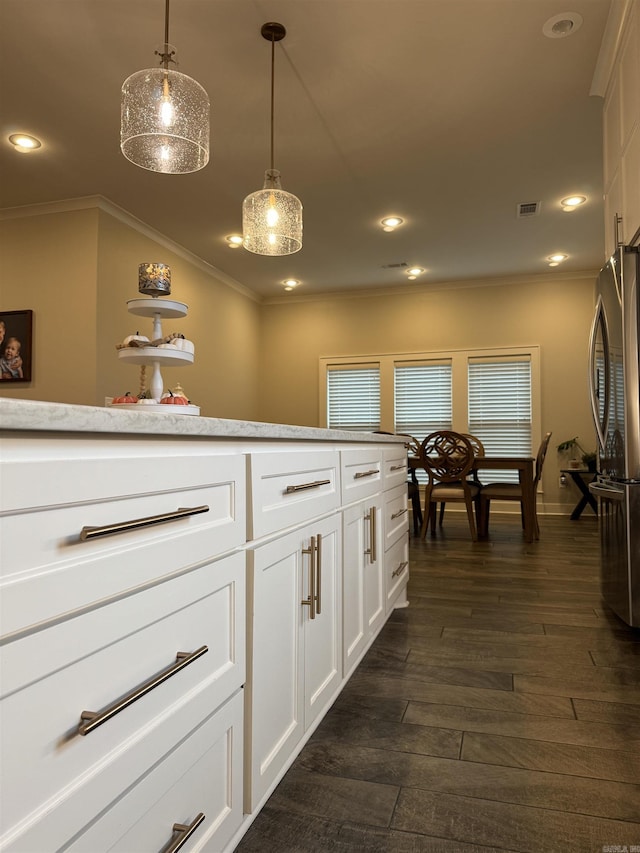 2560 Lilac Dr, Conway, AR 72034 - kitchen with crown molding, freestanding refrigerator, dark wood finished floors, recessed lighting, and pendant lighting