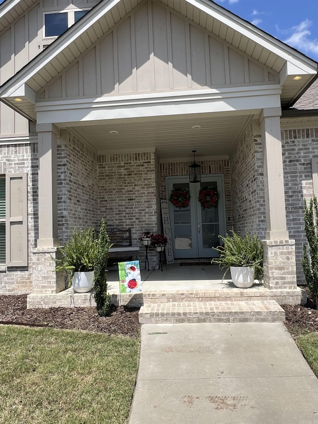 2560 Lilac Dr, Conway, AR 72034 - entrance to property featuring board and batten siding, brick siding, french doors, and a porch