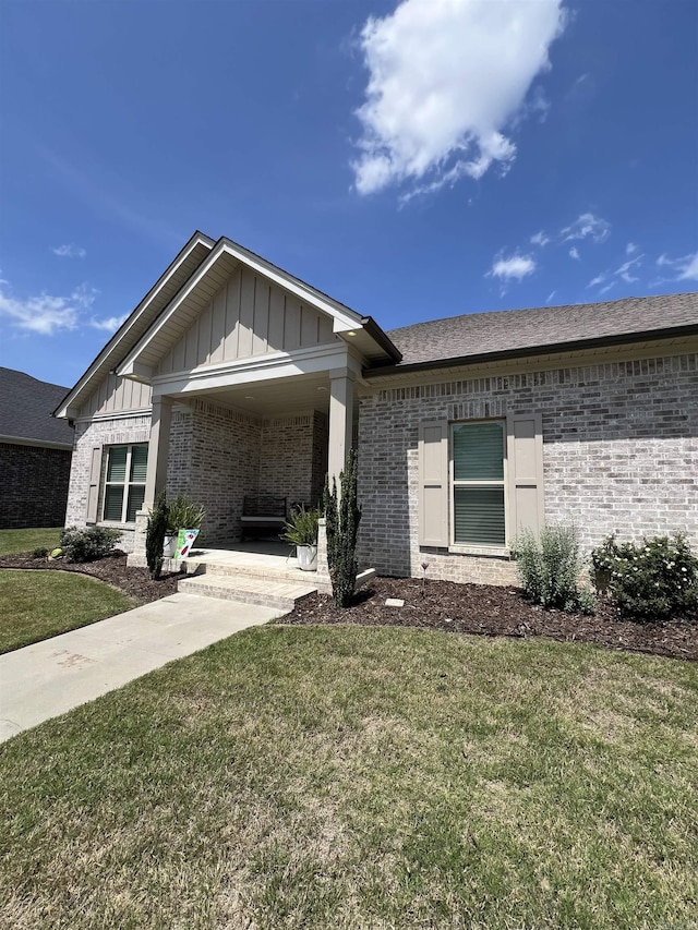 2560 Lilac Dr, Conway, AR 72034 - ranch-style house featuring brick siding, board and batten siding, and a front yard