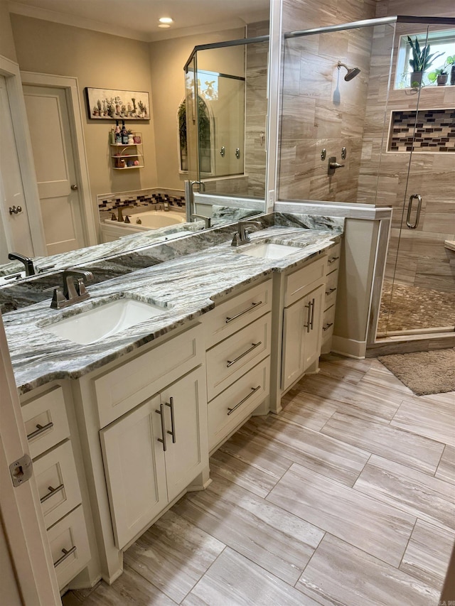 2560 Lilac Dr, Conway, AR 72034 - bathroom featuring a sink, a shower stall, a bathtub, and double vanity