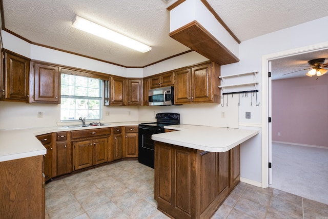 kitchen featuring a sink, a textured ceiling, a peninsula, stainless steel microwave, and black range with electric cooktop