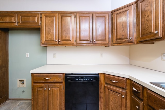 kitchen with black dishwasher, brown cabinets, and light countertops