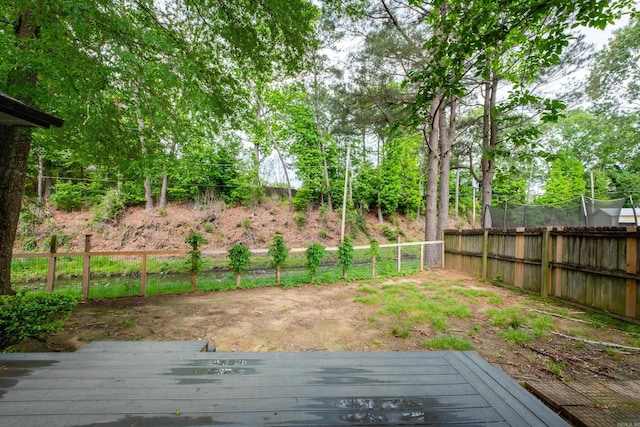 view of yard featuring fence and a deck