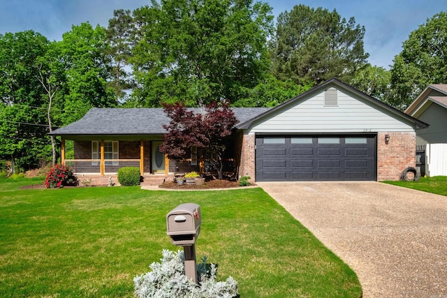 single story home featuring a porch, driveway, a front yard, brick siding, and an attached garage