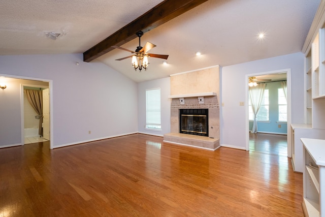 unfurnished living room featuring a ceiling fan and wood finished floors