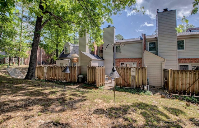 2200 Andover Ct, Little Rock, AR 72227 - rear view of property featuring brick siding, fence, and a chimney