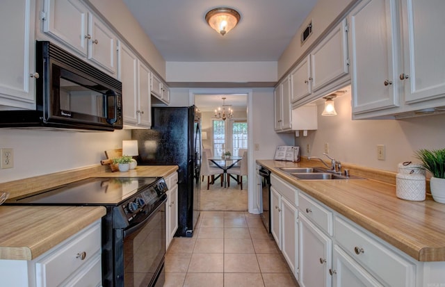 2200 Andover Ct, Little Rock, AR 72227 - kitchen with a sink, light countertops, white cabinets, black appliances, and a chandelier