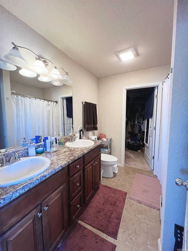 4630 Bedrock Dr, Jonesboro, AR 72404 - full bath with double vanity, a sink, a walk in closet, and toilet