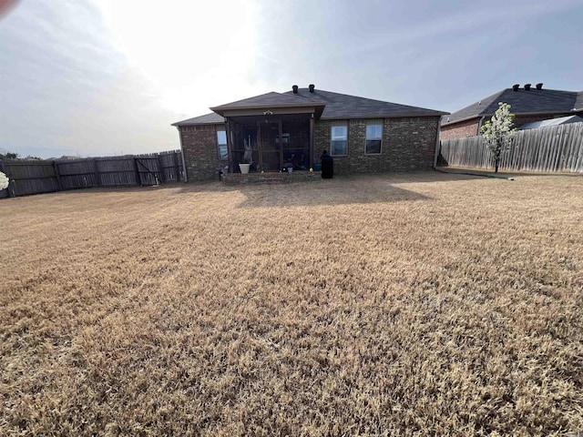 4630 Bedrock Dr, Jonesboro, AR 72404 - back of house with a fenced backyard, a yard, and brick siding