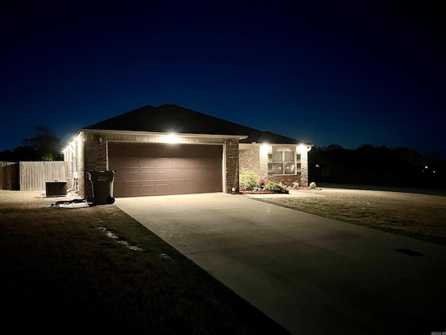 4630 Bedrock Dr, Jonesboro, AR 72404 - ranch-style house with fence, stone siding, central AC unit, concrete driveway, and an attached garage