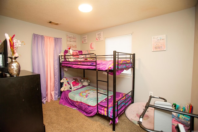 carpeted bedroom featuring visible vents