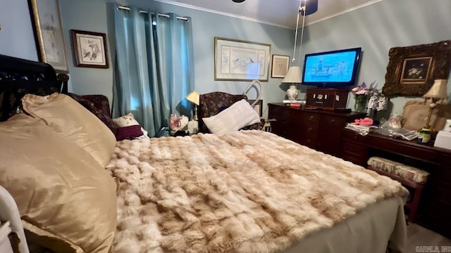 bedroom with ornamental molding and ceiling fan