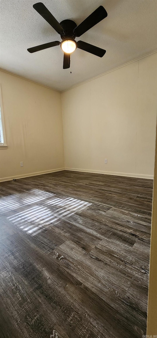 empty room with baseboards, a textured ceiling, ceiling fan, and wood finished floors