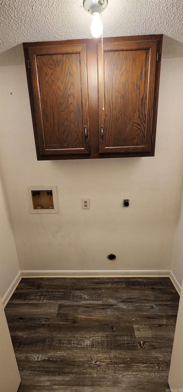 laundry room with dark wood-style flooring, baseboards, a textured ceiling, cabinet space, and washer hookup