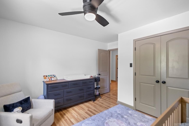 bedroom featuring light wood-type flooring, ceiling fan, and a closet