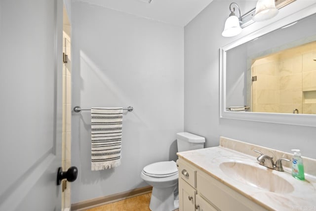 bathroom with vanity, tile patterned flooring, and toilet