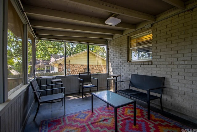 sunroom featuring beamed ceiling