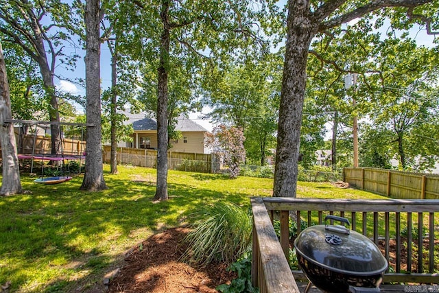view of yard featuring a fenced backyard and a trampoline