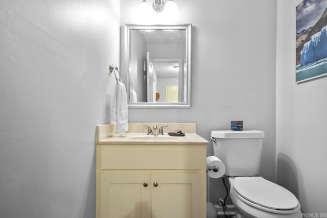 bathroom featuring toilet and vanity