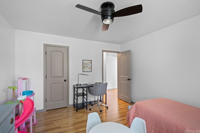 bedroom with ceiling fan and light wood-style flooring